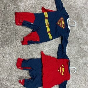Two Superman outfits. 0-3 month